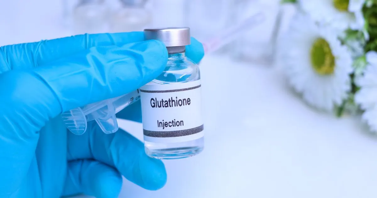 Glutathione injection vial held by a gloved hand in Torrance, CA