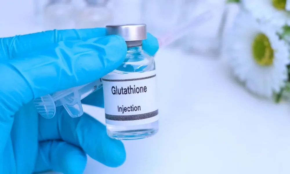 Glutathione injection vial held by a gloved hand in Torrance, CA